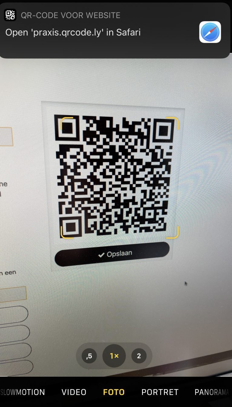 Iphone taking a picture of a QR-code while a safari pop-up appears asking if the user wants to go to the URL of the QR-code.